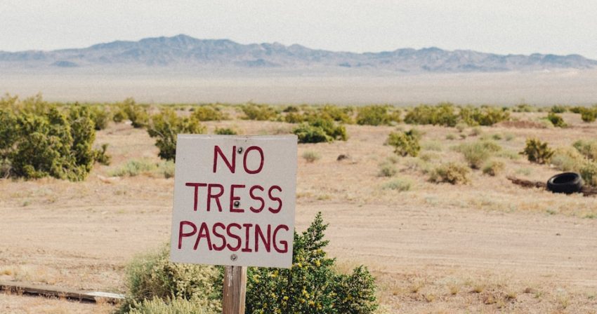 a no tress passing sign in the middle of nowhere